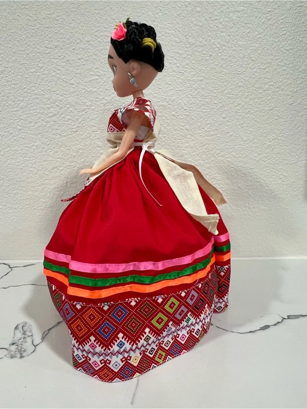 Red Traditional Folk Doll with Colorful Ribbon Accents